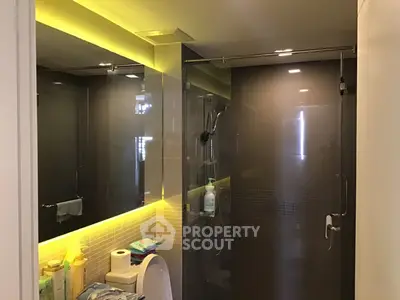 Modern bathroom with sleek glass shower and ambient lighting