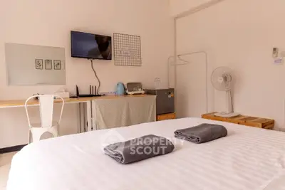 Cozy bedroom with modern amenities and minimalist decor