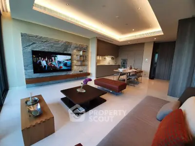 Luxurious modern living room with open kitchen, stylish furniture, and large wall-mounted TV.