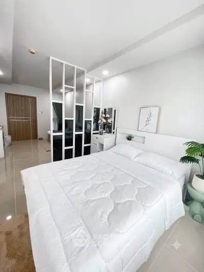 Modern bedroom with sleek design and elegant decor, featuring a comfortable bed and stylish partition.