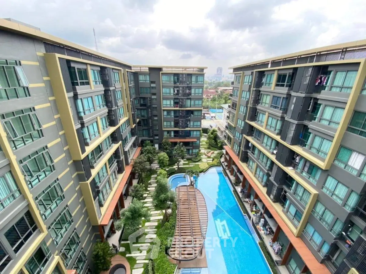 Modern apartment complex with pool and garden view, perfect for urban living.