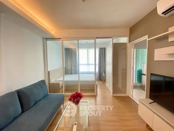 Modern studio apartment with glass partition and cozy living area