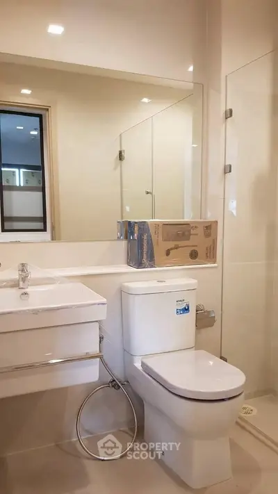 Modern bathroom with sleek fixtures and glass shower enclosure