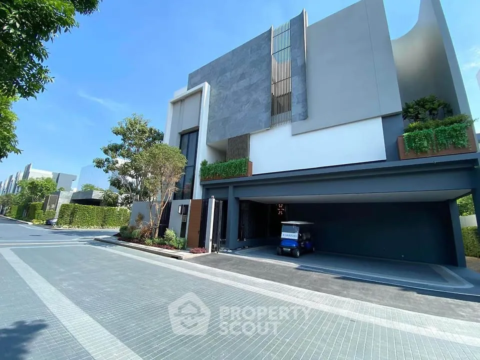 Modern luxury house exterior with sleek design and lush greenery, showcasing contemporary architecture and spacious driveway.