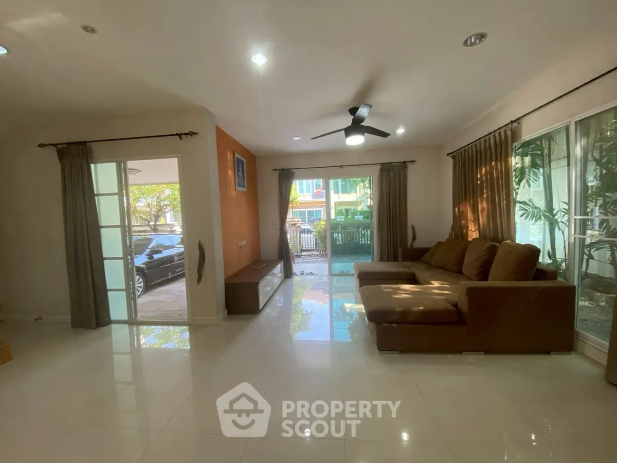 Spacious living room with modern decor and large windows for natural light.