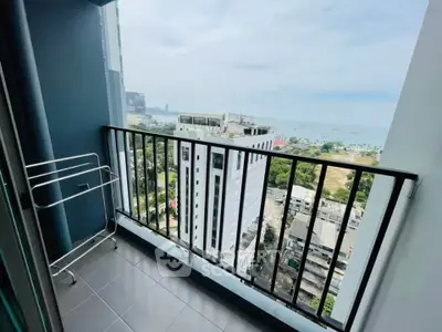 Stunning high-rise balcony with panoramic city and ocean views, perfect for relaxation and enjoying the scenery.