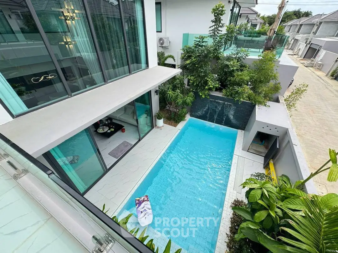 Luxurious modern home with private pool and lush greenery, perfect for relaxation and entertainment.
