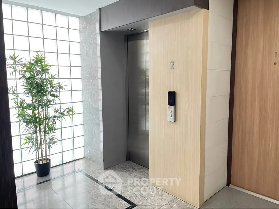 Modern elevator lobby with sleek design and natural light