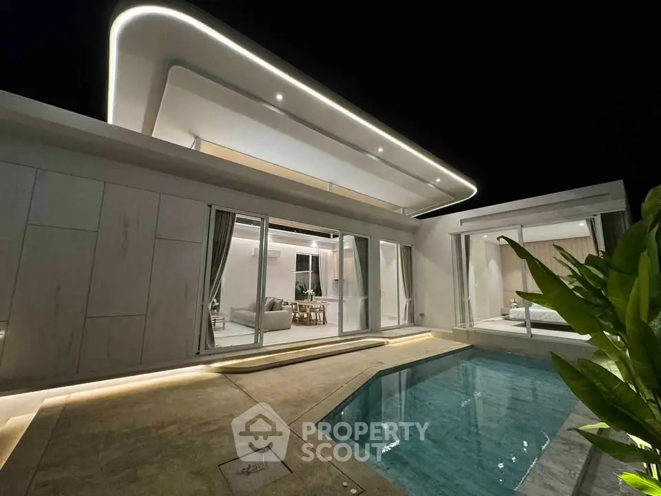 Modern luxury villa with sleek design and private pool at night