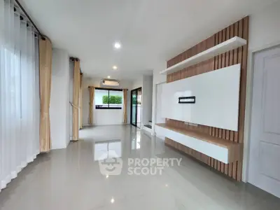 Spacious modern living room with sleek design and large windows for natural light.