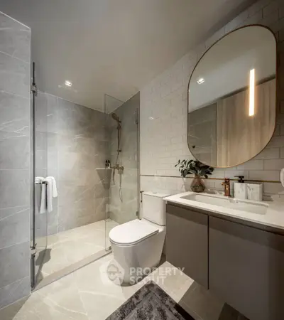 Modern bathroom with sleek design, glass shower, and elegant fixtures in a contemporary home.