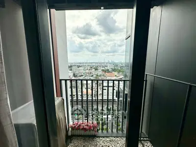 Stunning balcony view with cityscape and cloudy sky, perfect for urban living.