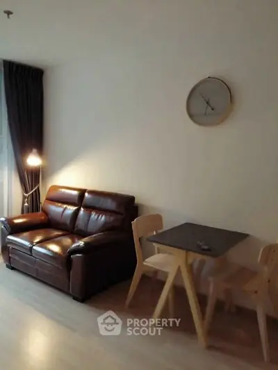 Cozy living room with leather sofa and modern dining set, perfect for urban living.