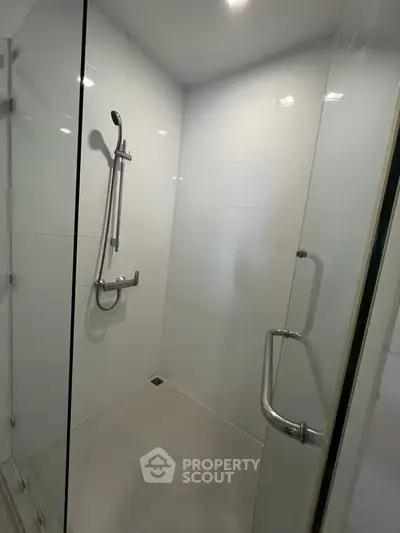 Modern shower area with glass enclosure and sleek fixtures in a contemporary bathroom.