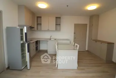 Spacious modern kitchen with island and ample storage in a stylish apartment.