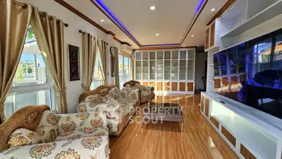 Luxurious living room with elegant decor and large windows offering natural light.