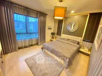 Elegant bedroom with modern decor and large window view