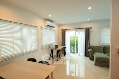 Bright and airy living room with modern furnishings and large windows.