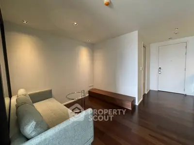 Modern minimalist living room with sleek wooden flooring and stylish furniture
