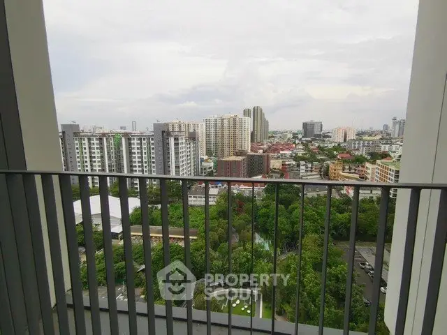 Stunning cityscape view from a high-rise balcony overlooking lush greenery and urban skyline.