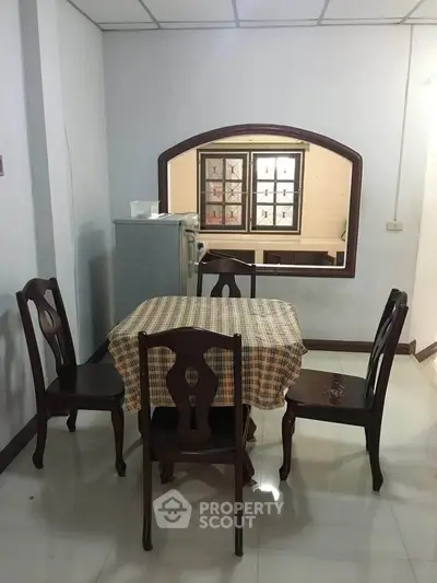 Cozy dining area with classic wooden chairs and table in a bright room