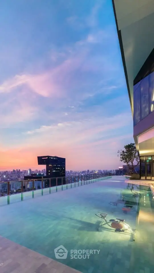 Stunning rooftop pool with panoramic city views at sunset, perfect for luxury living.