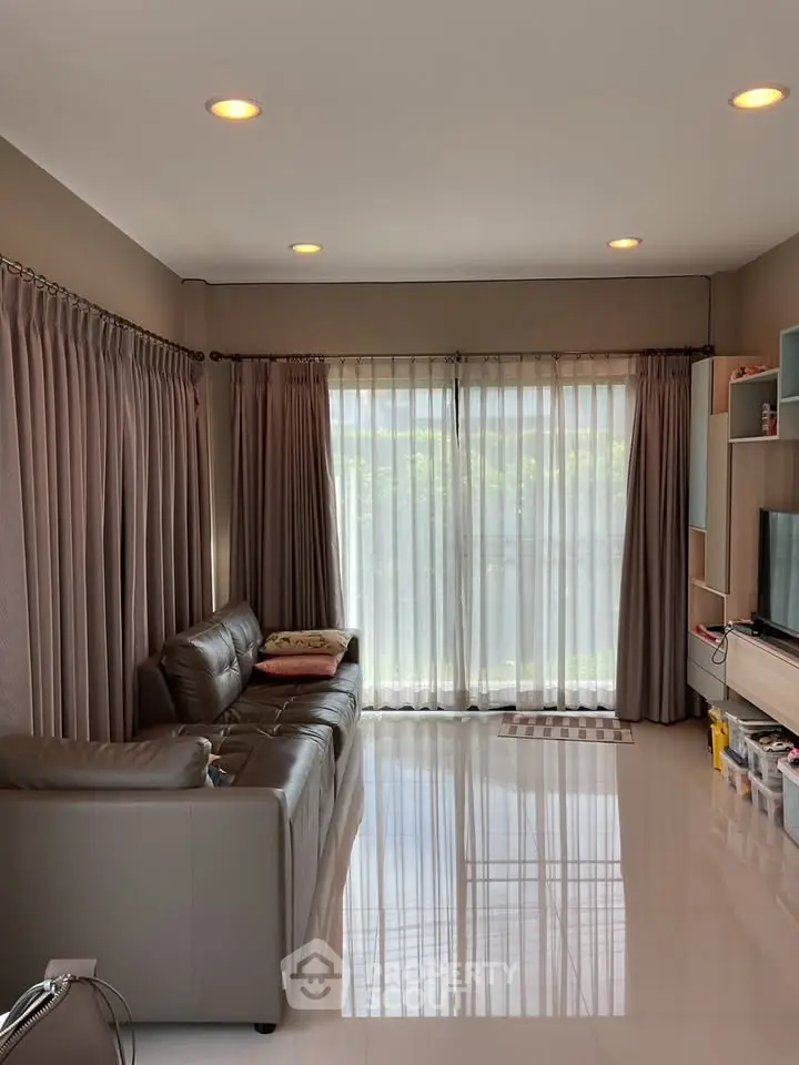 Spacious living room with modern decor and large windows for natural light.