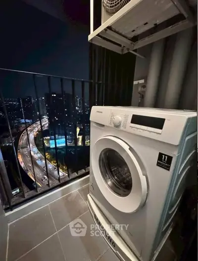 Modern balcony with washing machine and stunning city night view