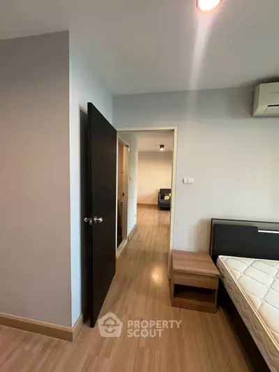 Modern bedroom with wooden flooring and sleek furniture in a stylish apartment