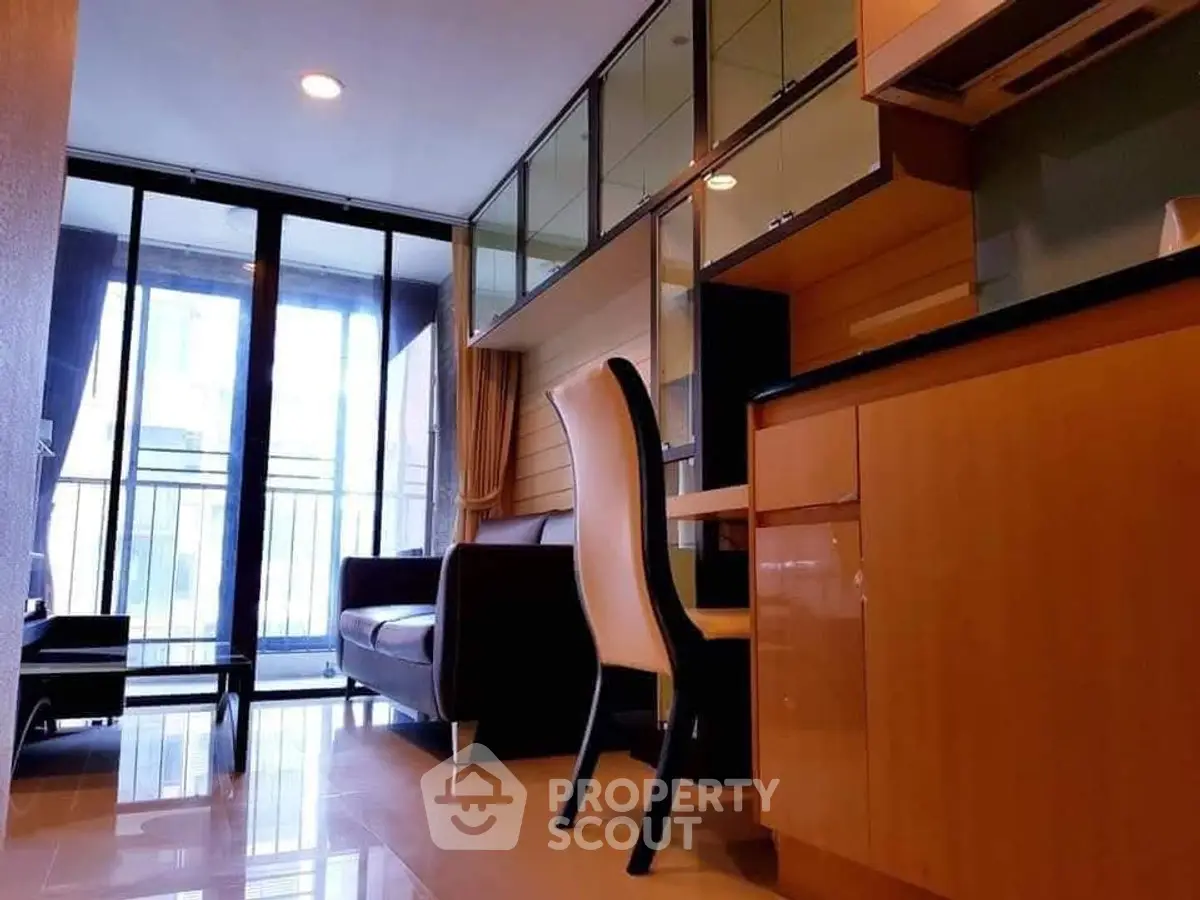 Modern living room with sleek furniture and large windows for natural light.