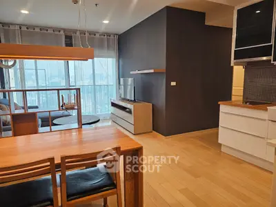 Modern open-plan living room with city view and stylish furniture