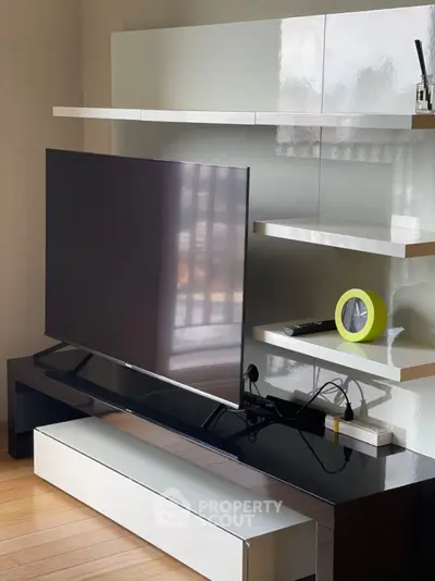 Modern living room with sleek TV unit and stylish shelving, perfect for contemporary home decor.