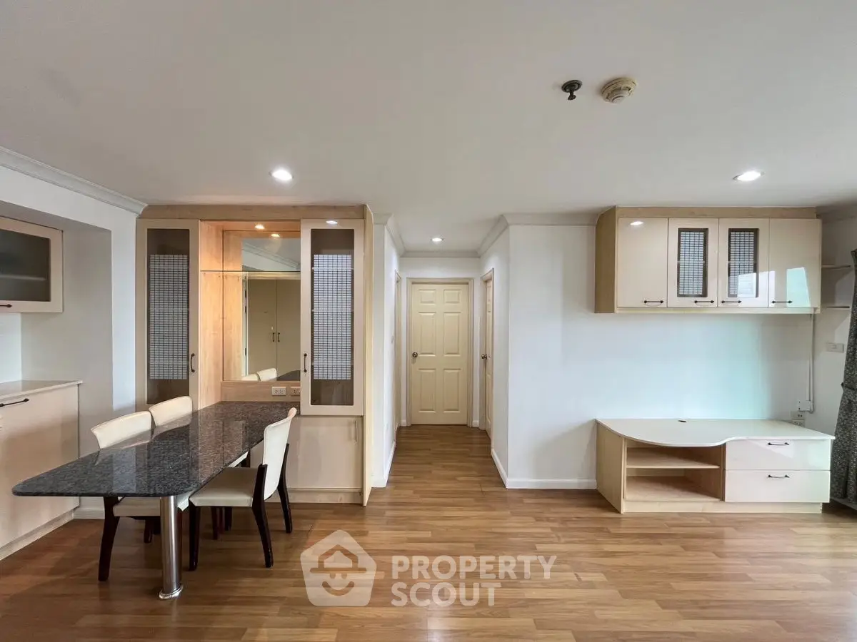 Spacious open-plan living area with modern furnishings and wooden flooring