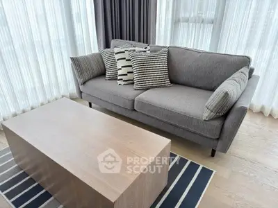 Stylish modern living room with elegant sofa and wooden coffee table, perfect for urban living.
