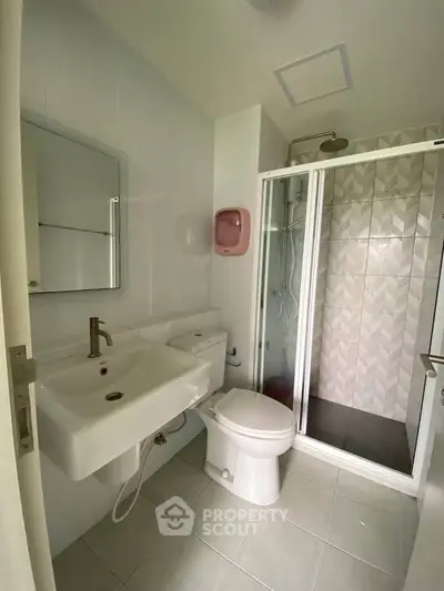 Modern bathroom with shower and sleek fixtures in a contemporary home.