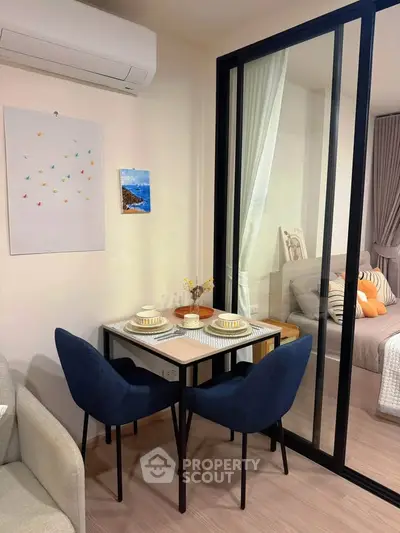 Cozy dining area with modern decor and glass partition in stylish apartment