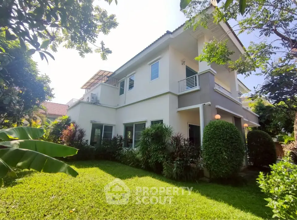 Charming two-story house with lush garden and modern exterior design, perfect for family living.