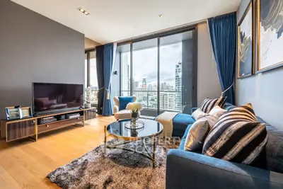 Luxurious modern living room with city view, elegant decor, and spacious balcony access.