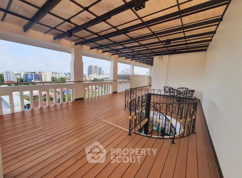 Spacious rooftop terrace with city views and elegant railing design.