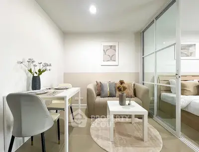 Modern living room with cozy seating and dining area, featuring elegant decor and neutral tones.