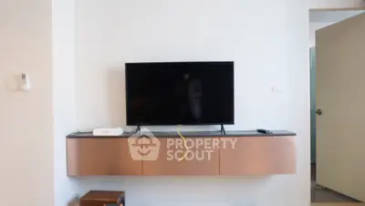 Modern living room with wall-mounted TV and sleek storage unit