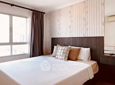Elegant bedroom with stylish wallpaper and cozy bedding in a modern apartment.