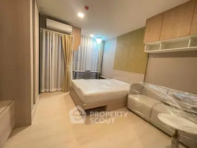 Modern bedroom with cozy furnishings and natural light, featuring a comfortable bed and stylish decor.