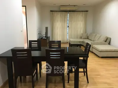 Spacious living room with modern furniture and natural light, perfect for relaxation and entertainment.