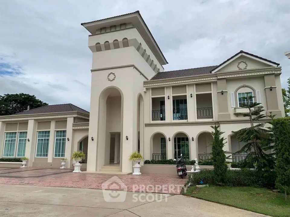 Luxurious Mediterranean-style villa with grand entrance and lush landscaping, perfect for upscale living.