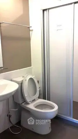 Modern bathroom with shower and toilet in compact space
