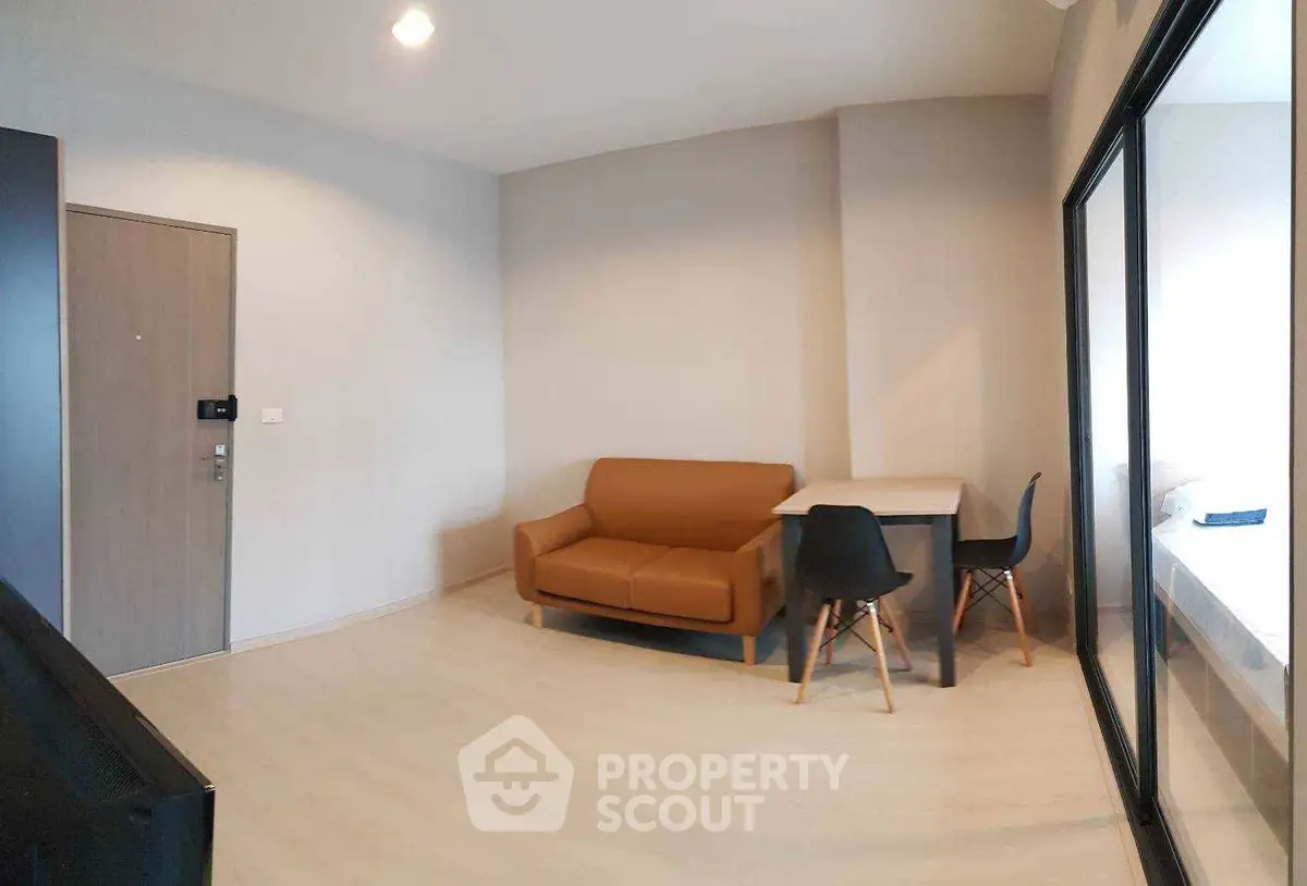 Modern minimalist living room with cozy sofa and dining area