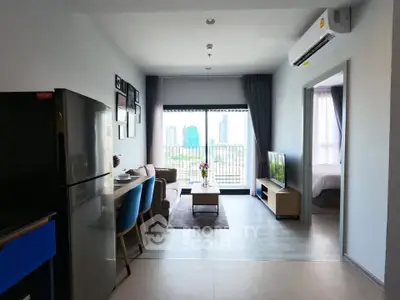 Modern open-plan living room with city view, featuring sleek furniture and natural light.
