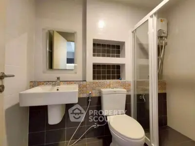 Modern bathroom with shower enclosure and stylish tile accents