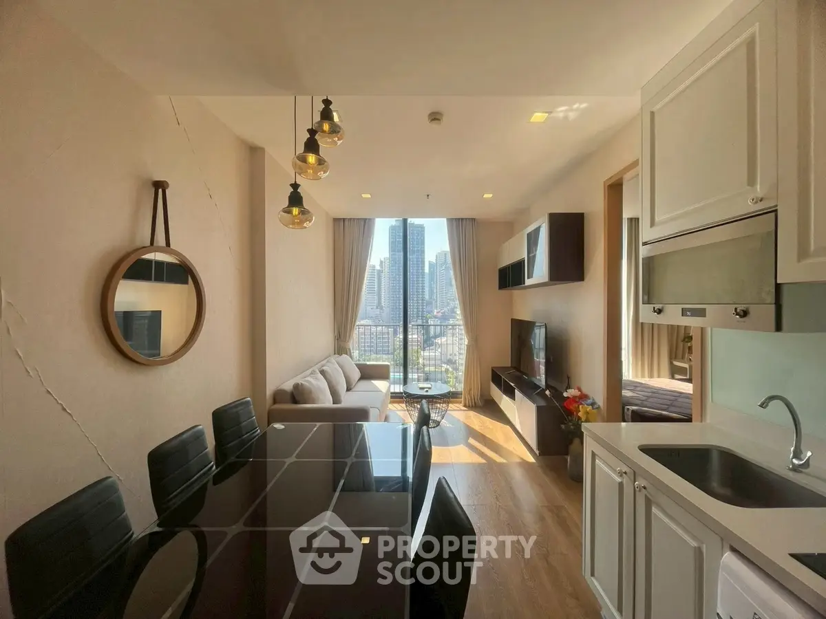 Modern living room with city view, open kitchen, and stylish decor in a high-rise apartment.